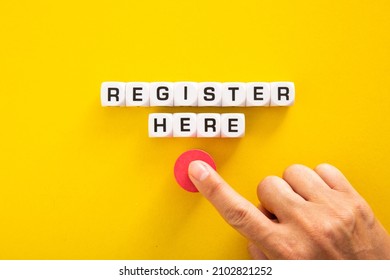 Hand pushing button with Register Here word.