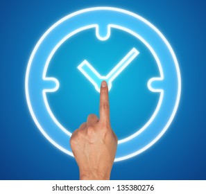 Hand pushing clock button on a touch screen interface