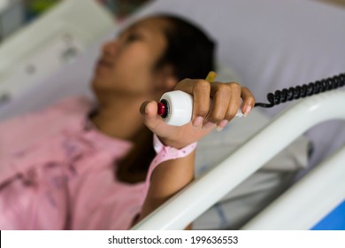 hand pushing nurse call button 