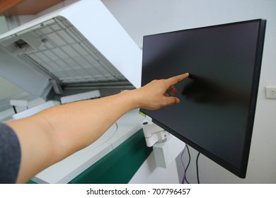 hand pushing on a touch screen interface