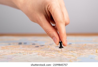 Hand Pushing Pin On Map. Trip Planning. Woman Marking Travel Destination, Location With Pushpin. High Quality Photo