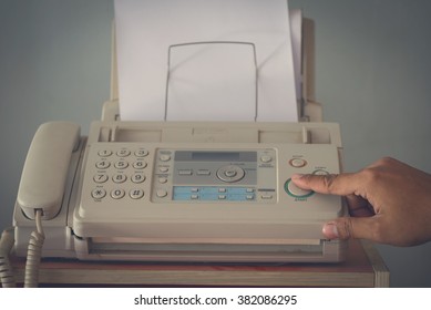 A hand pushing start button old fax retro style