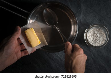 Hand Put The Butter In A Bucket For Making Roux