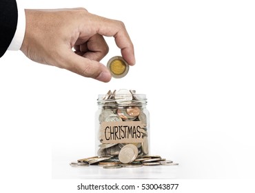 Hand Put Coin In Glass Jar, Saving Money For Christmas, On White Background