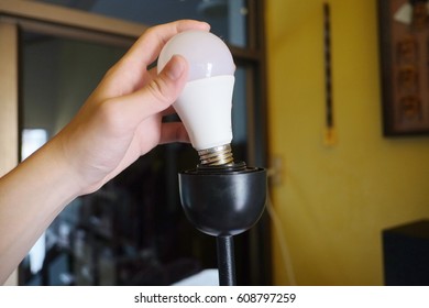 Hand Put Led Light Bulb On Lamp