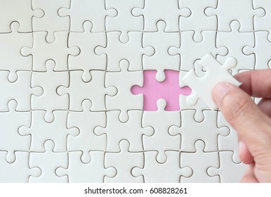 hand put missing jigsaw puzzle , solution concept ,key for success