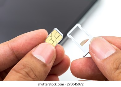 Hand Put Sim Card To The Sim Card Tray