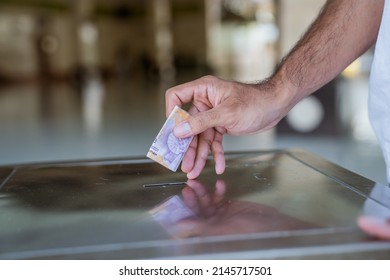 Hand Put Some Money In To The Charity Box In The Mosque