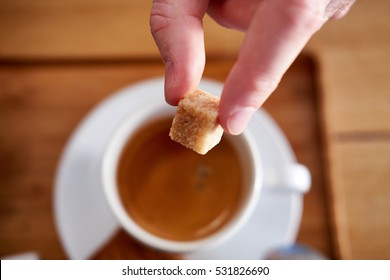 Hand Puts A Sugar Cube In The Coffee Cup