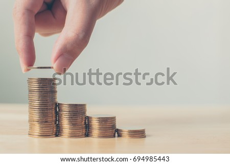 Hand putting coin stack step up increase save money, Finance and investment concept
