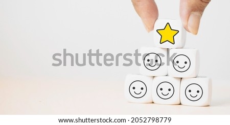 Hand putting dice cube with icon face smiley feedback, best excellent business services rating customer experience, Satisfaction survey.kid evaluation reward, encourage.Mental health, child emotion.