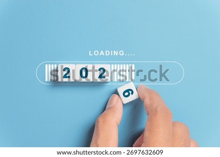 Hand putting dice for loading progress from 2025 to 2026 to countdown merry christmas and happy new year concept.