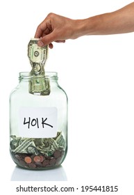 Hand Putting A Dollar Bill In A 401k Savings Jar