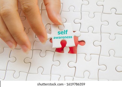 Hand Putting A Last Jigsaw Puzzle ; Self Awareness Concept