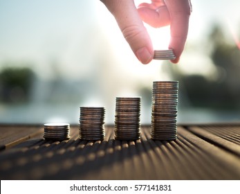 Hand putting money coins stack growing, saving money for purpose concept - Shutterstock ID 577141831