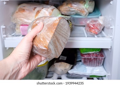 A Hand Putting A Package Of Brown Bread In Reserve On A Shelf Of A Home Freezer, Long Life Food Storage Concept