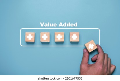 Hand putting plus sign which use download style which mean value added , positive thinking and personal development concept. - Shutterstock ID 2101677535