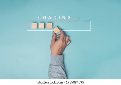 Hand putting wooden cube block with infographic for download on blue background , Technology and business progress concept.