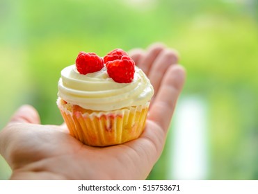 Hand with Raspberry Cupcake
