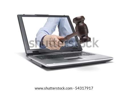 a hand reaches out of a laptop with a wooden hammer