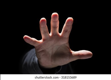 Hand reaching from the dark and grabbing or attacking concept for fear, domestic and child abuse