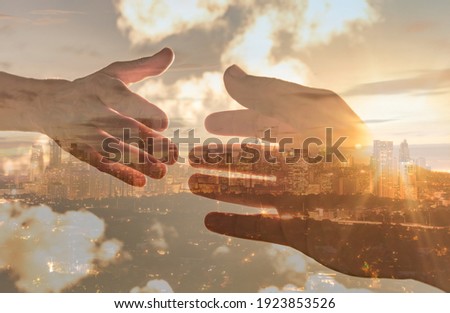 Hand reaching out for help int he city. Helping hand, compassion and assistance concept. 