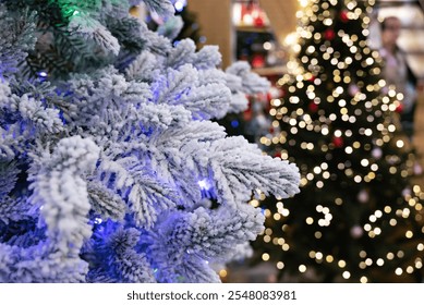 A hand reaching out to a snowy tree branch amidst festive lights. Background filled with colorful bokeh lights creating a cozy atmosphere - Powered by Shutterstock