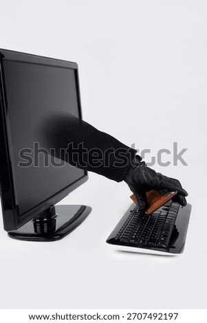 Hand reaching through computer screen holding a wallet during a digital theft attempt