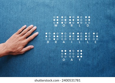 A hand reading braille with blue background. Annual celebration of World Braille Day on January 4. Day of the blind, world day of the blind, education day