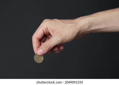 Hand ready to drop a coin. Saving and investment concept