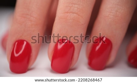Hand with red classic manicure on nails. Beautiful red manicure