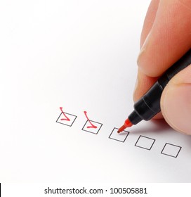 Hand With Red Pen Marking A Check Box