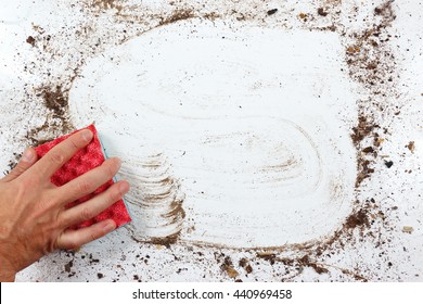 Hand With Red Sponge Wiping A Very Dirty Surface