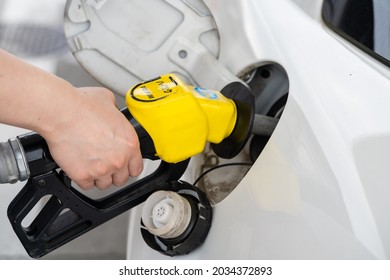 A Hand To Refuel A Car With High-octane Gasoline.