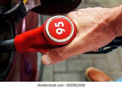 Hand, Refuelling A Passenger Car. Fuel Pump With The Number 95. Top View