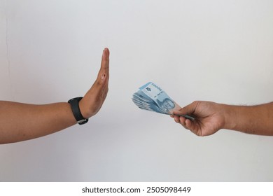 Hand refusing and don't receive bribe money. Concept of anti bribery and anti corruption