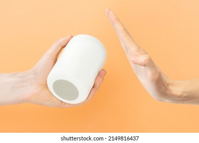 Man’s Hand Refusing A White Soup Thermos Food Jar On An Orange Background.  Meal. Mock. Mockup. Negative. New. Object. Outdoor. Pack. Picnic. Plastic. Pot. Proof. Refuse. Reject