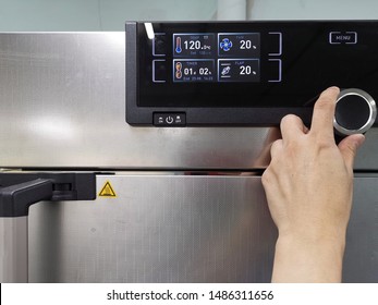 Hand regulated the temperature or timing of the oven - Shutterstock ID 1486311656