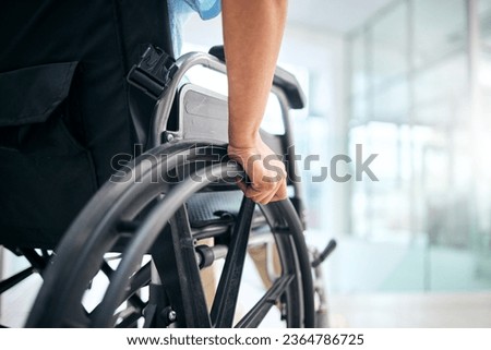 Hand, rehabilitation and person in a wheelchair at a hospital for medical support, transportation and mobility. Closeup, help and a patient with a disability in a chair at a clinic for recovery