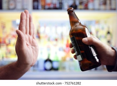 Hand rejecting alcoholic beer beverage concept for alcoholism and addiction