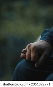 Hand and ring closeup with a blurry depth of field 