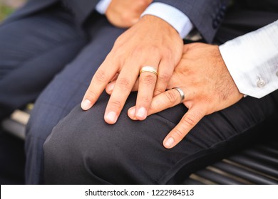 A hand with ring of gay couple in the park on their wedding day - Powered by Shutterstock