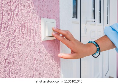 Hand Ringing On Doorbell On Pvc Front Door