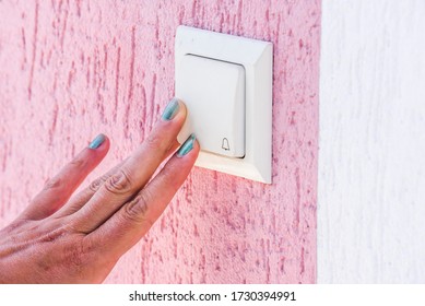 Hand Ringing On Doorbell On Pvc Front Door 