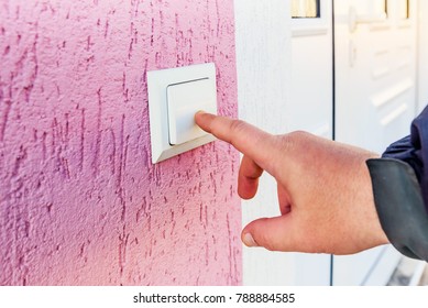 Hand Ringing On Doorbell On Pvc Front Door