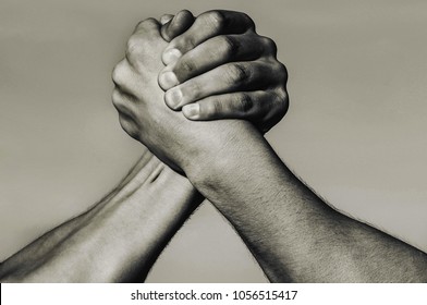 Hand, rivalry, vs, challenge, strength comparison. Two muscular hands. Rivalry concept. Man hand. Two men arm wrestling. Arms wrestling. Leadership concept, hands. Closep up, macro. Black and white.