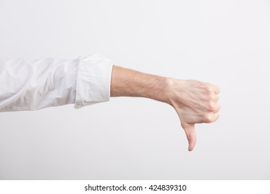 Hand With Rolled Sleeve With Thumb Down In A Studio