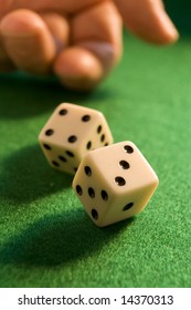 Hand Rolling Dice Onto A Green Baize