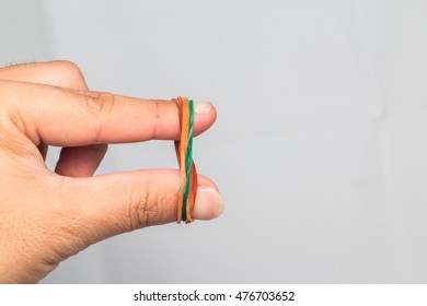 A Hand With Rubber Band , Elastic Band On Hands, Isolated On White