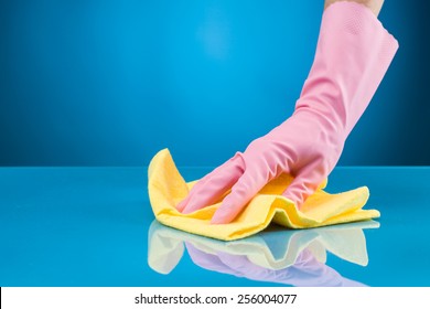 Hand With Rubber Glove Cleaning Surface With Microfiber Cloth